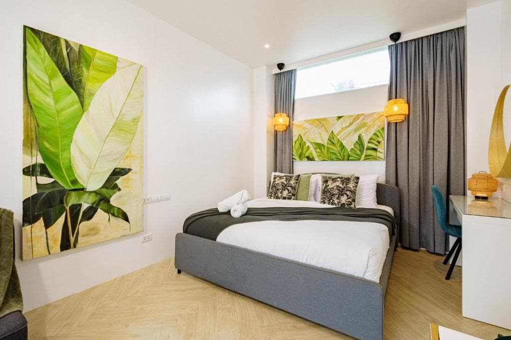 Luxury suite bedroom with tropical artwork and king-size bed