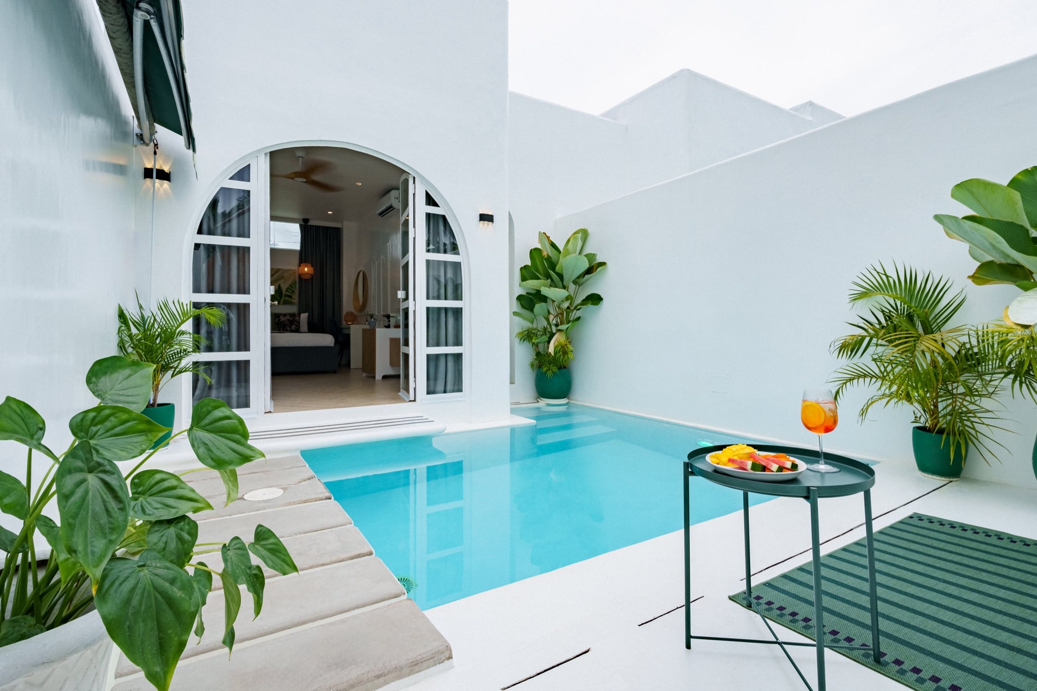 Amanzohi Siargao private pool suite with turquoise water and cocktails